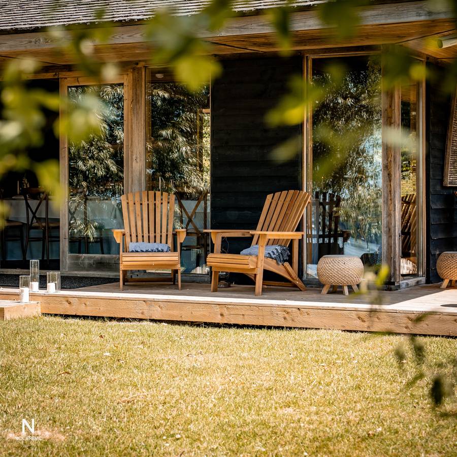 Timber lakeside cabin terrace with Adirondack chairs at Lakes by Yoo