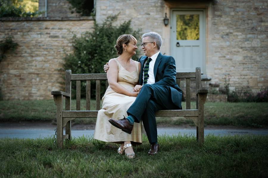 Couple on a bench in Swinbrook village