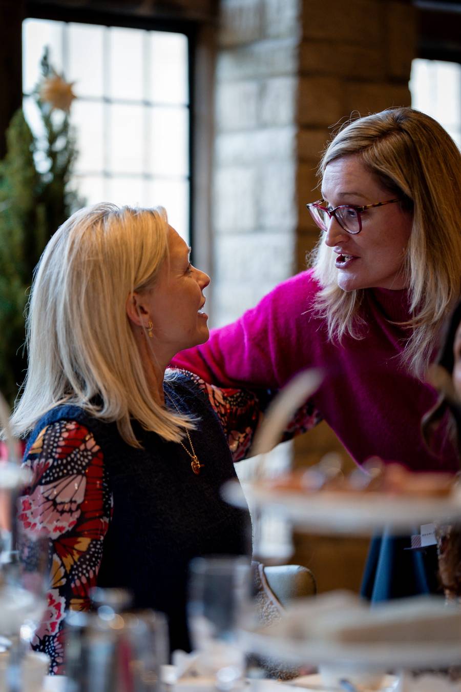 Guests in conversation at a Woman's Chapter networking event at The Manor House, Castle Combe